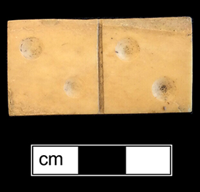 Ivory Domino. 1.5" x .75" - from 18BC27. The game of dominoes  originated in China and made its way to Italy in the early 18th century. Game pieces were often made of ivory and ebony (The Strong). 